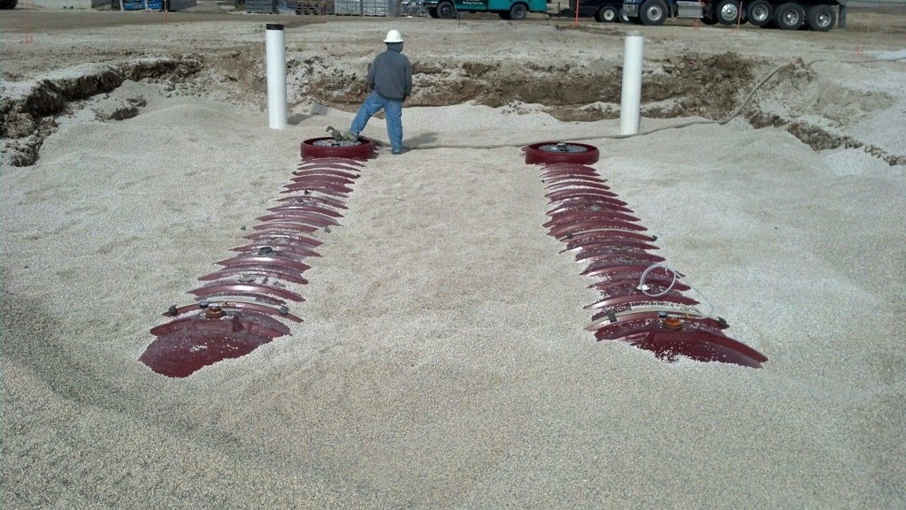 Employee standing on covered tanks